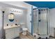 Bathroom showcasing a glass shower, toilet, vanity, and decorative mirror with vanity lighting at 6310 W County Road 4, Berthoud, CO 80513