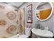 Bathroom featuring decorative shower tiles, a modern sink, and tasteful artwork at 6310 W County Road 4, Berthoud, CO 80513