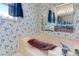 The bathroom features a beige bathtub and floral wallpaper at 6310 W County Road 4, Berthoud, CO 80513