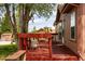 Charming deck featuring red floors, decorative wagon wheels, and a comfortable seating area at 6310 W County Road 4, Berthoud, CO 80513