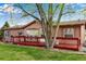 Quaint ranch style home with a charming red deck and mature trees at 6310 W County Road 4, Berthoud, CO 80513
