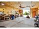 Spacious garage featuring a workshop area, ample storage, and an open door showcasing the exterior at 6310 W County Road 4, Berthoud, CO 80513