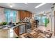 Well-lit kitchen with stainless steel appliances, wood cabinets, and a breakfast bar for casual dining at 6310 W County Road 4, Berthoud, CO 80513