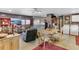 Living room features ceiling fan, dining table, TV, couch, cabinets, and stacked laundry machines at 6310 W County Road 4, Berthoud, CO 80513