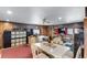 Living room features ceiling fan, dining table, TV, couch, cabinets, and built-in storage units at 6310 W County Road 4, Berthoud, CO 80513