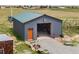 Spacious building featuring a durable metal exterior with a door, gravel area and outdoor cooking at 6310 W County Road 4, Berthoud, CO 80513