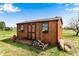 Exterior shot of shed with wooden deck, wood pile, and flower boxes at 6310 W County Road 4, Berthoud, CO 80513