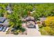 Aerial view of the property featuring solar panels, lush landscaping, and a driveway at 7379 S Lafayette W Cir, Centennial, CO 80122
