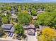 Aerial view of the property featuring solar panels, lush landscaping, and a driveway at 7379 S Lafayette W Cir, Centennial, CO 80122