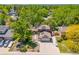 Aerial view of home with solar panels, mature trees, well-manicured lawn, and a basketball hoop at 7379 S Lafayette W Cir, Centennial, CO 80122