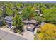 Aerial view of the property featuring solar panels, lush landscaping, and a driveway at 7379 S Lafayette W Cir, Centennial, CO 80122