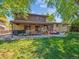 Wide shot of backyard with a covered patio and relaxing backyard patio at 7379 S Lafayette W Cir, Centennial, CO 80122