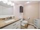 This well-lit bathroom includes a granite vanity, and a step stool by the toilet at 7379 S Lafayette W Cir, Centennial, CO 80122