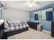 Cozy bedroom with blue accent wall, plush carpet, and ample natural light at 7379 S Lafayette W Cir, Centennial, CO 80122