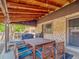Comfortable covered patio featuring a dining table, string lights, and ample seating at 7379 S Lafayette W Cir, Centennial, CO 80122