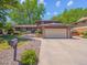 Charming exterior of a two-story home with a two-car garage, lush lawn, and neatly landscaped walkway at 7379 S Lafayette W Cir, Centennial, CO 80122