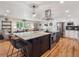 Bright kitchen with stainless steel appliances and granite countertops flows into the open living area at 7379 S Lafayette W Cir, Centennial, CO 80122