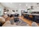 An open-concept living area showcasing modern decor, a stylish kitchen, and lots of comfortable seating at 7379 S Lafayette W Cir, Centennial, CO 80122