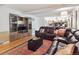 Inviting living room with a comfortable leather sectional, custom built-ins, and open sight lines to the kitchen at 7379 S Lafayette W Cir, Centennial, CO 80122