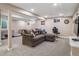 Comfortable basement living room area with a plush sectional and warm carpeting at 7379 S Lafayette W Cir, Centennial, CO 80122