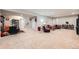 Finished basement with neutral walls and carpet, with multiple seating areas at 3630 Gold Bug St, Aurora, CO 80019
