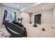 Finished basement features space for activities with a workout area and a basketball hoop at 3630 Gold Bug St, Aurora, CO 80019