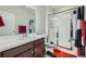 Clean bathroom featuring a glass enclosed shower, modern vanity and a tile floor at 3630 Gold Bug St, Aurora, CO 80019