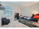 bedroom features a gaming chair, TV, themed bedding, and natural light at 3630 Gold Bug St, Aurora, CO 80019