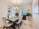 Bright dining room with stylish table, chandelier, decor, and a view to the kitchen at 3630 Gold Bug St, Aurora, CO 80019