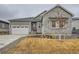 Charming single-Gathering home featuring stone accents, a two-car garage, and a well-manicured front yard at 3630 Gold Bug St, Aurora, CO 80019