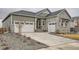 Charming home featuring stone accents, a two-car garage, and a well-maintained front yard landscape design at 3630 Gold Bug St, Aurora, CO 80019