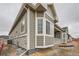Charming single-Gathering home featuring stone accents, large bay windows, and neutral gray siding at 3630 Gold Bug St, Aurora, CO 80019