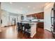 Well-lit kitchen featuring an island with seating, stainless steel appliances, and dark wood cabinets at 3630 Gold Bug St, Aurora, CO 80019