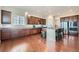 Gourmet kitchen featuring wooden floors, stainless appliances, ample counter space, and a center island at 3630 Gold Bug St, Aurora, CO 80019