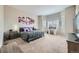 Spacious main bedroom with a sitting area by a large bay window and a vanity at 3630 Gold Bug St, Aurora, CO 80019