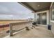 A covered patio has space for grilling and dining while overlooking an open landscape at 3630 Gold Bug St, Aurora, CO 80019