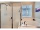 Close up of shower and garden tub with window in bathroom at 3630 Gold Bug St, Aurora, CO 80019