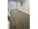 Finished basement area with neutral carpeting, window for natural light, and white trim at 3575 S Ouray St, Aurora, CO 80013
