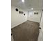 Finished basement area with neutral carpeting, window for natural light and white trim at 3575 S Ouray St, Aurora, CO 80013