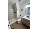 Contemporary bathroom with a shower featuring gray subway tile and a wood vanity with black hardware at 3575 S Ouray St, Aurora, CO 80013