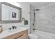 Modern bathroom featuring sleek vanity, stylish mirror, and shower with rainfall showerhead at 3575 S Ouray St, Aurora, CO 80013