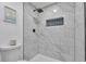 Modern bathroom featuring luxurious tiled shower with black hardware and a decorative recessed shelf at 3575 S Ouray St, Aurora, CO 80013