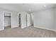 Spacious bedroom with neutral carpet, open doors to bathroom and closet, and recessed lighting at 3575 S Ouray St, Aurora, CO 80013