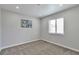Minimalist bedroom bathed in natural light with soft carpet and fresh paint at 3575 S Ouray St, Aurora, CO 80013