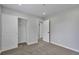 Neutral bedroom with closet space, plush carpet, and a doorway to additional rooms at 3575 S Ouray St, Aurora, CO 80013