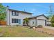 Charming two-story home featuring a well-manicured lawn and a bright blue front door at 3575 S Ouray St, Aurora, CO 80013