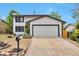 Traditional white house with a spacious two-car garage and a well-maintained driveway at 3575 S Ouray St, Aurora, CO 80013