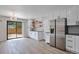 Bright kitchen with stainless steel appliances, modern lighting, and a view to the backyard at 3575 S Ouray St, Aurora, CO 80013
