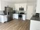 Modern kitchen features stainless steel appliances, grey countertops, and white cabinetry at 3575 S Ouray St, Aurora, CO 80013