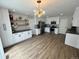 Bright kitchen with white cabinets, stainless steel appliances, and luxury vinyl plank flooring at 3575 S Ouray St, Aurora, CO 80013